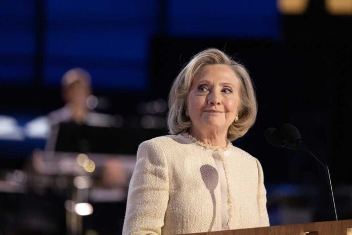 Hilary Cawthorne at a podium with microphones