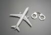 VIDEO: Hollywood Star Cuffed After Midair Mayhem Toy airplane with metal handcuffs on gray background