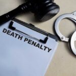 Death By Choice – State Acts Fast Clipboard with death penalty document beside gavel and handcuffs